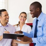 top real estate agent | couple signing papers