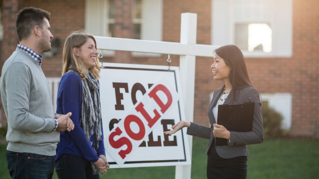A couple talking to a real estate agent