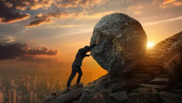Illustration of a man pushing a heavy boulder uphill, symbolizing the stress of selling a house with a real estate agent.