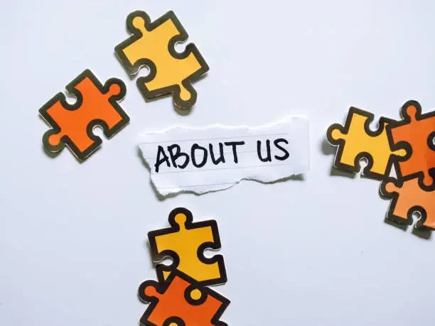 Orange and yellow puzzle pieces connecting together, symbolizing teamwork, trust, and the personalized solutions offered by our home buying team.