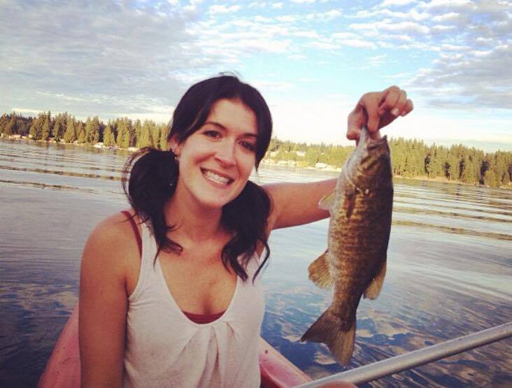Amy Wagner- Real Estate Agent, fishing on Lake Goodwin a caught fish in hand