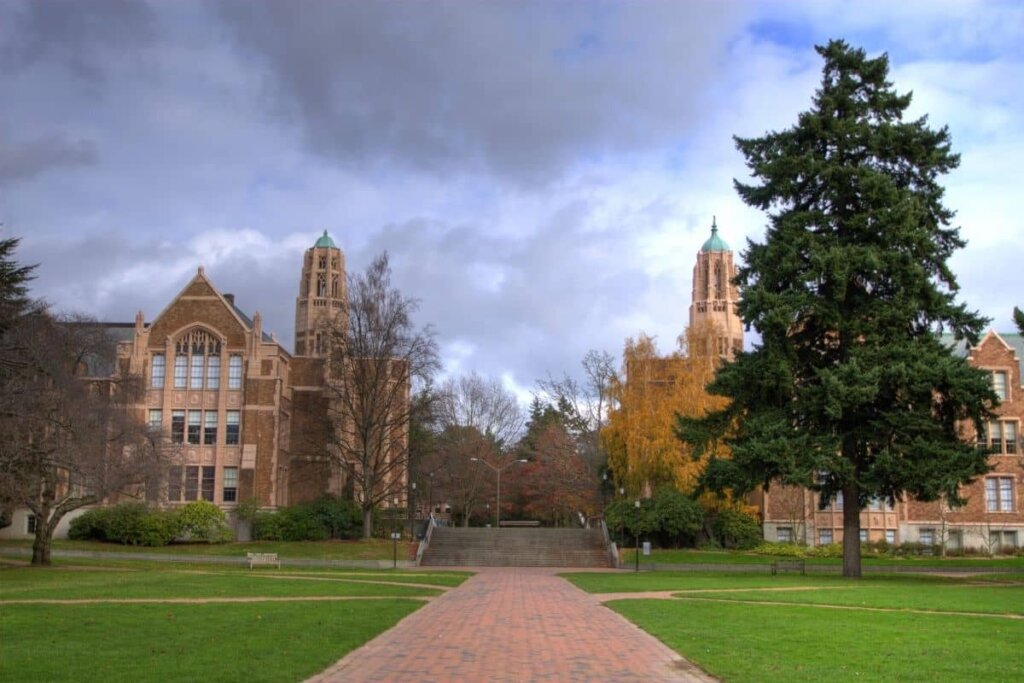 View of University of Washington, brick building with evergreen trees around.