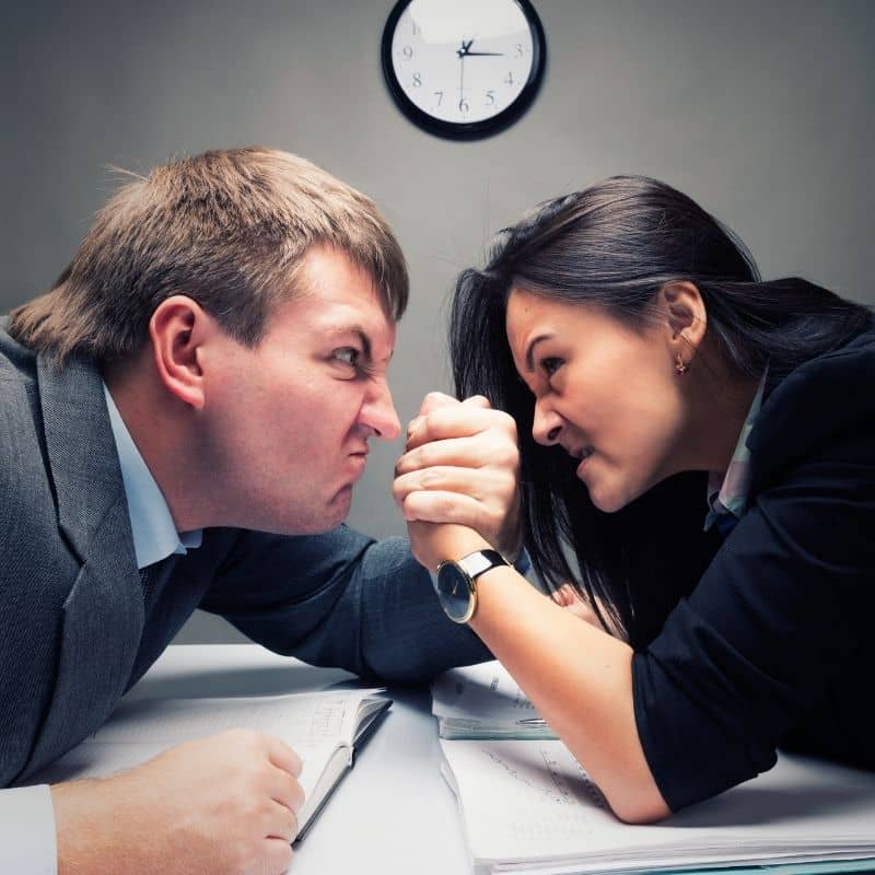Two people in an arm wrestle competition