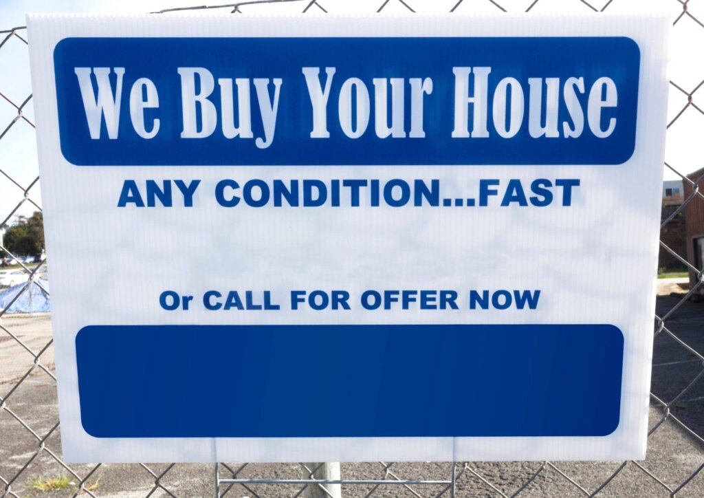 a white and blue yard sign that says "we buy your house any condition....fast"