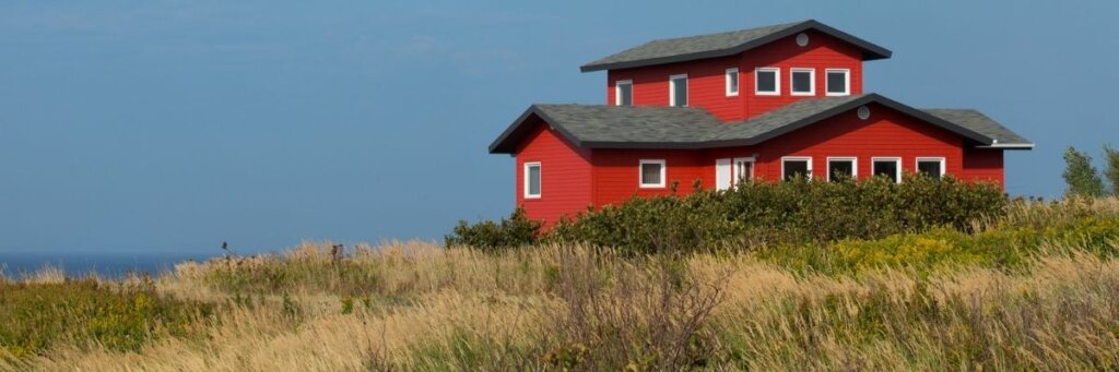 red house sourounded by lots of land