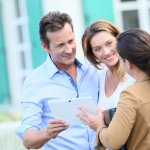 couple talking to an expert to price their home in houston to sell fast