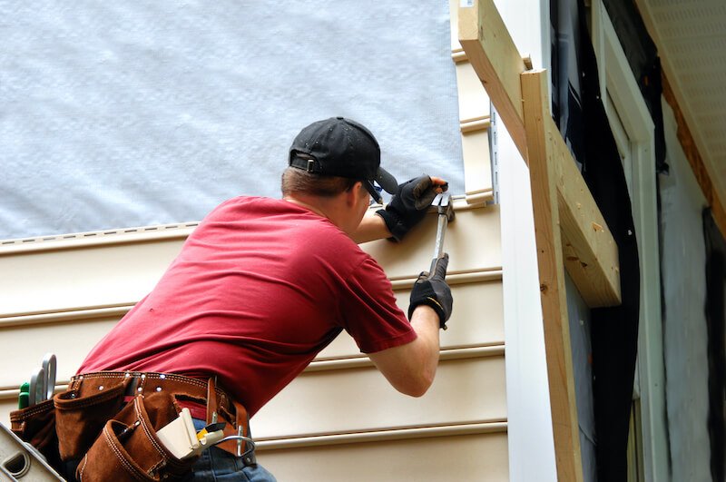 a man making small repairs on a house for sale as-is in houston