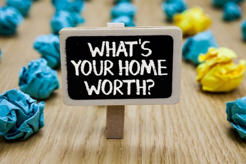 Text sign showing What is Your Home Worth question with paper lumps background