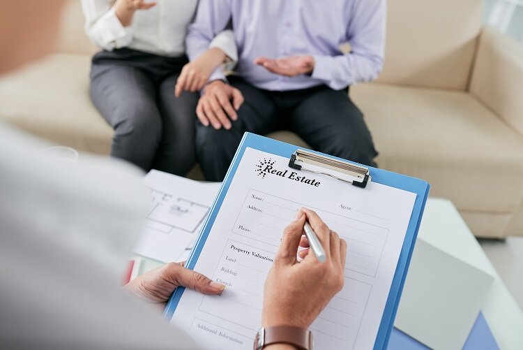 Close-up of female realtor filling in rental agreement