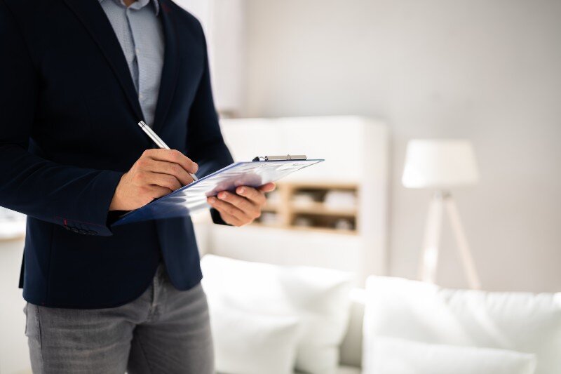 A home inspector goes through a checklist for a home appraisal.