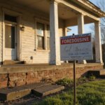 an old house with a foreclosure sign in front of it