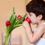 kid smelling flowers