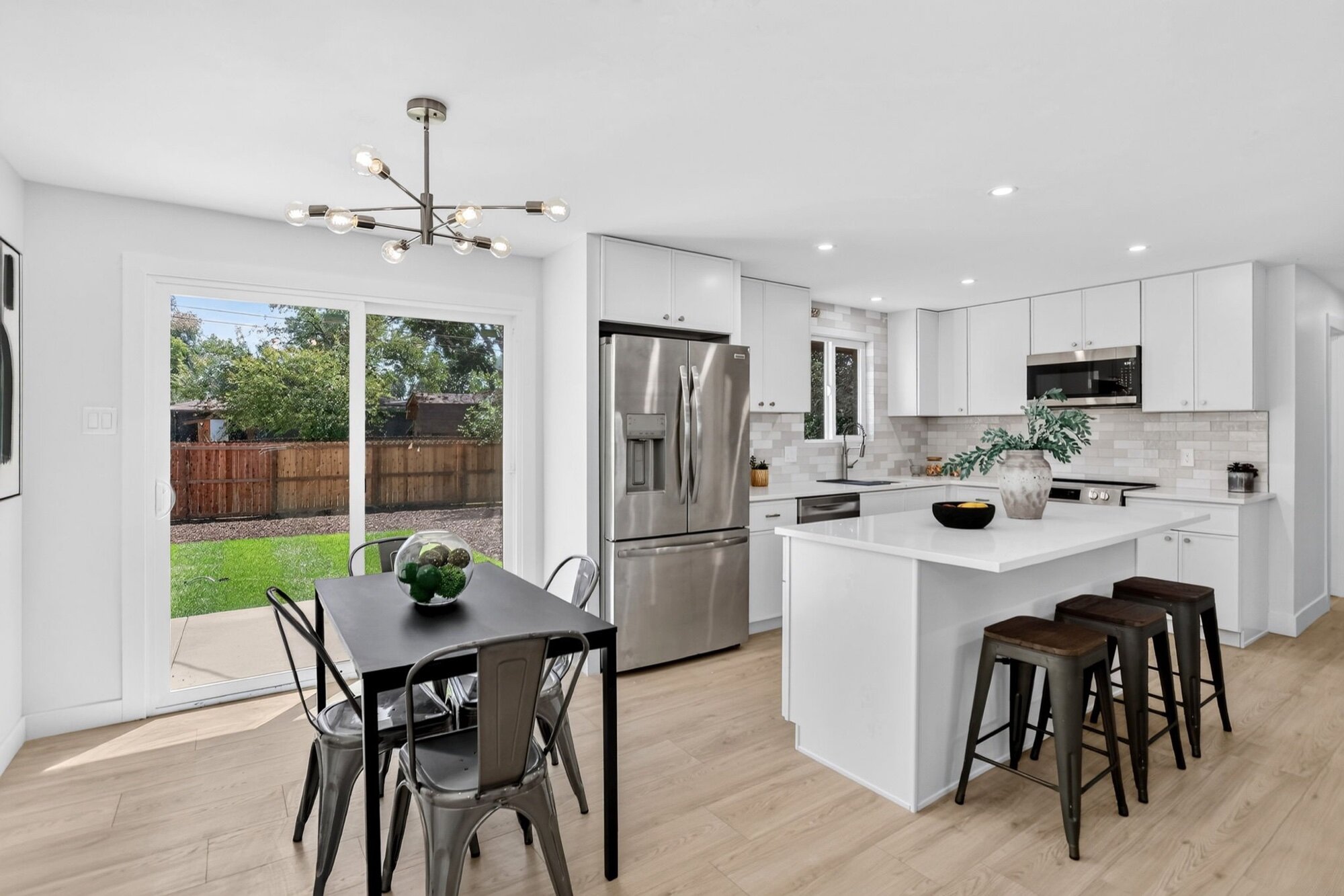 After: new white kitchen with quartz island at 1708 Jewel Dr, Longmont