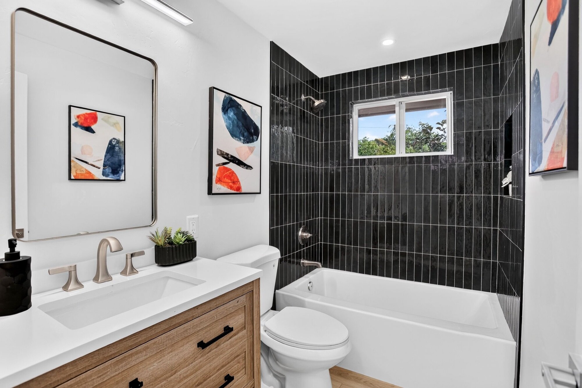 After: bathroom gutted and rebuilt with floor-to-ceiling tile at 1708 Jewel Dr, Longmont
