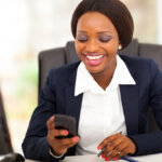 african american businesswoman reading sms