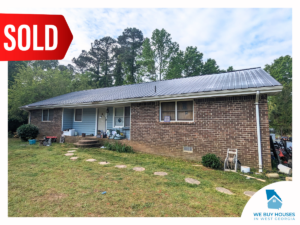 A ranch-style house with blue siding and brown brick [bought by We Buy Houses in West Georgia]