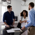 A couple shaking hands with a realtor in a flipped house