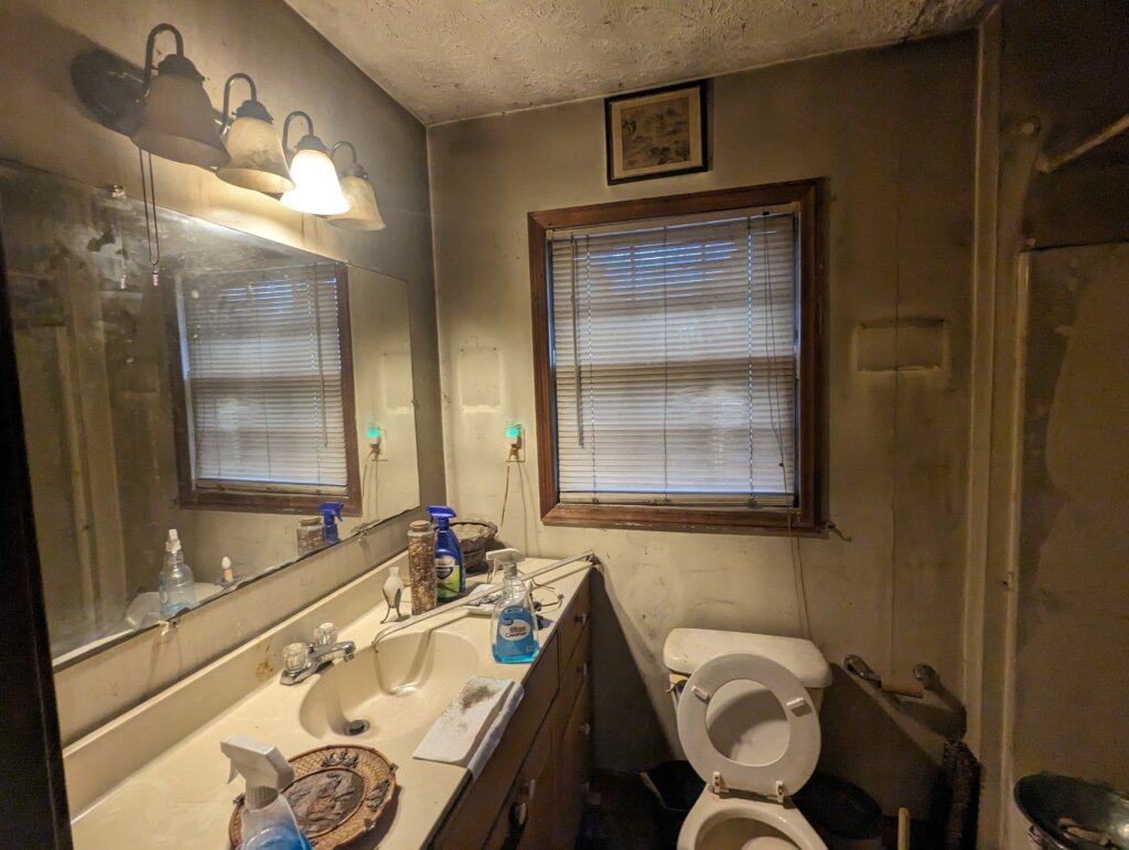 A bathroom of a purchased property in need of repairs