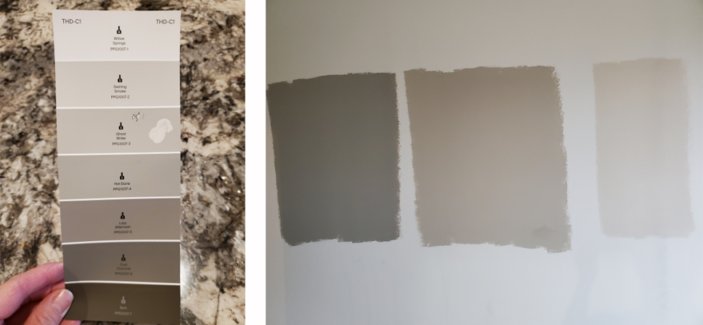 A paint card with seven shades from light gray to deep taupe beside three neutral swatches painted onto a white wall.