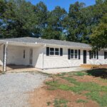 A ranch-style white house bought by We Buy Houses in West Georgia.