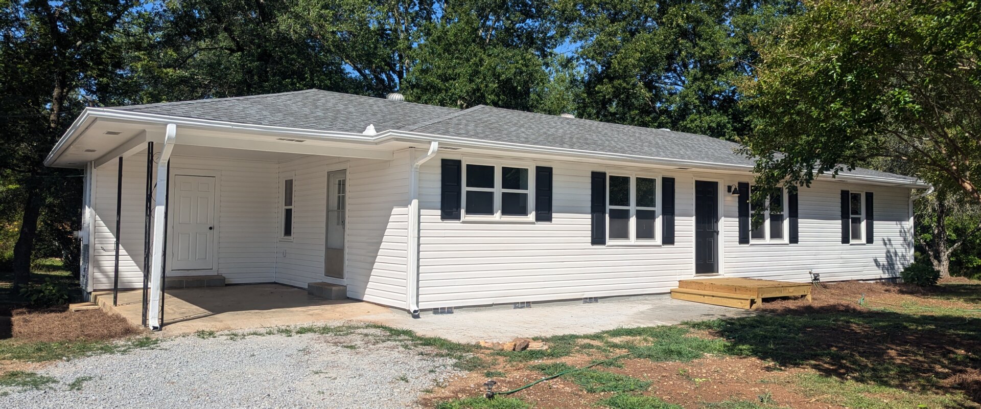 A ranch-style white house bought by We Buy Houses in West Georgia.