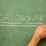 A green chalk board with "Foreclosure" written on it