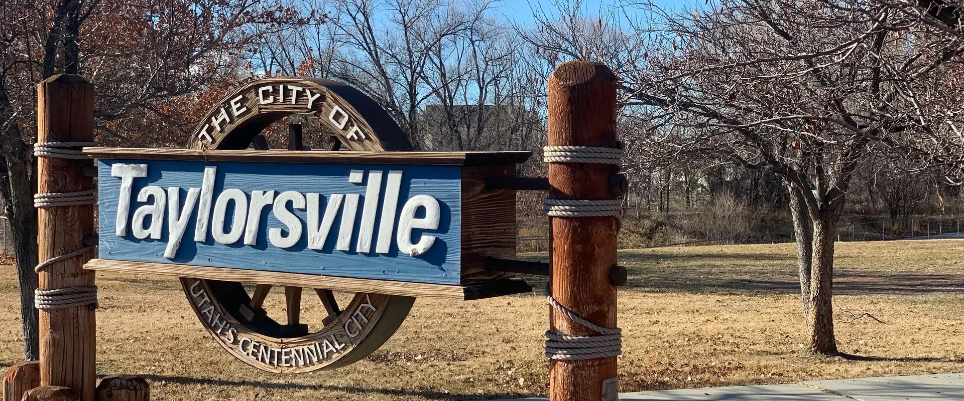 Alt Text: Welcome to Taylorsville sign at a local park, Utah Close Fast buys houses in Taylorsville.