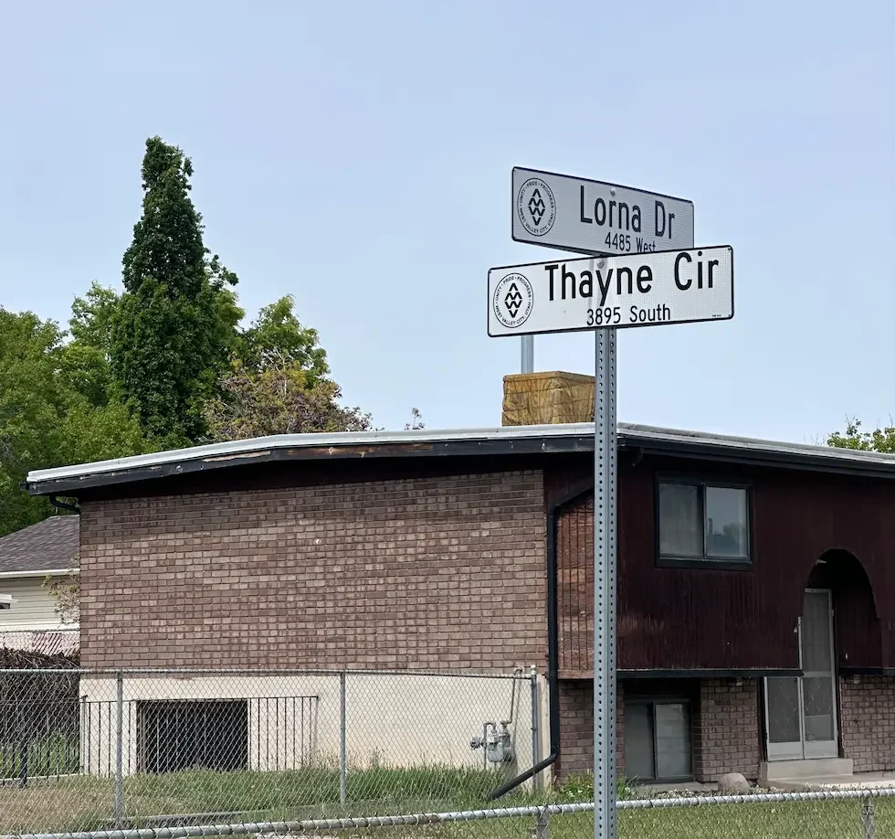 West Valley City Utah street sign at Lorna Dr and Thayne Cir — Utah Close Fast buys houses in this neighborhood