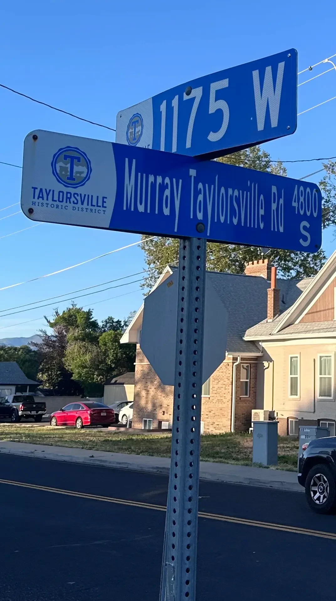 Murray Taylorsville Road and 1175 W street sign in Taylorsville Utah Historic District — Utah Close Fast cash home buyers serve this neighborhood