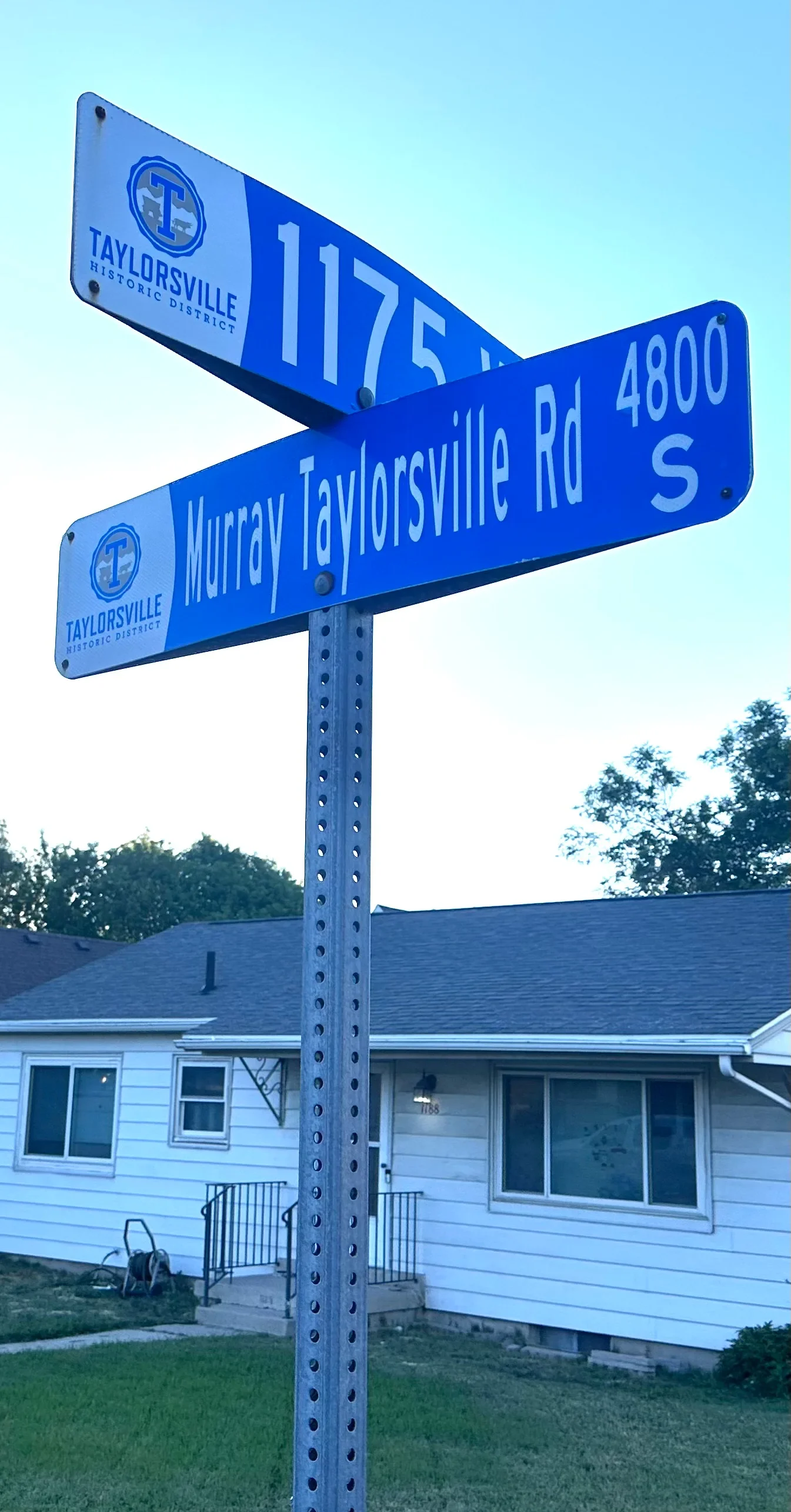 Taylorsville Historic District street sign on Murray Taylorsville Road at 4800 S with residential home in background