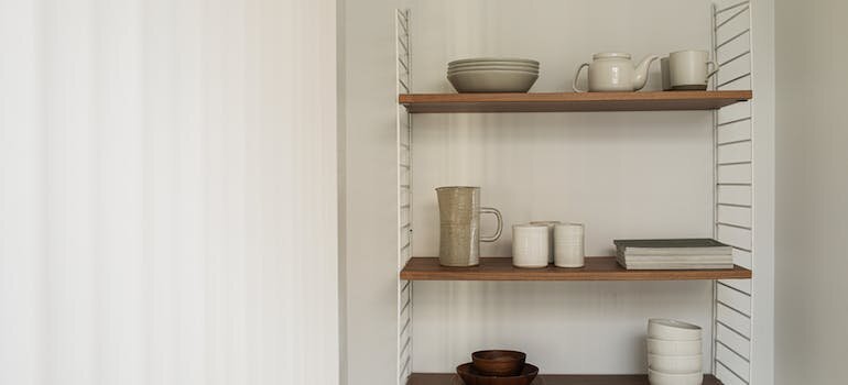 a shelf, cups, plates, in minimalistic design.
