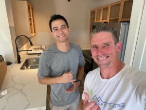 Greg and David from Maui Home Buyers standing in the kitchen while making repairs and renovations in a Maui condo we bought for cash fast