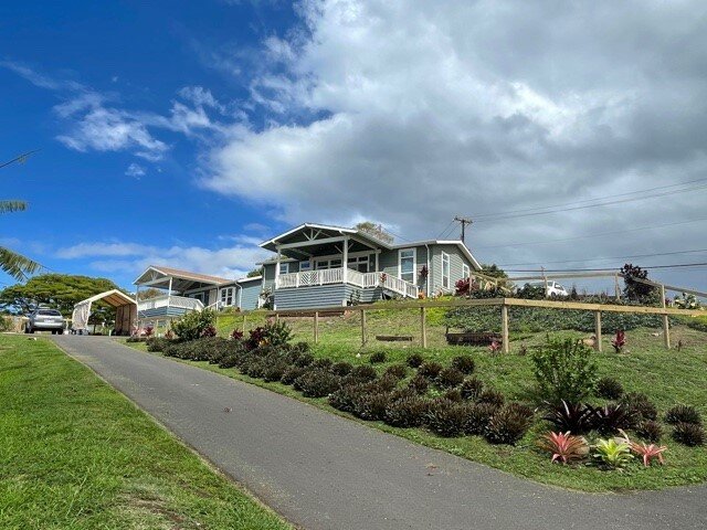 Street view of the front of two houses on a single piece of real estate property in Makawao, Hawaii on the island of Maui where the owners partnered with family members to save money on their home purchase and sale