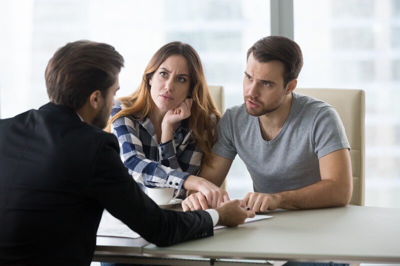 A couple having a heated argument about selling costs and fees.
