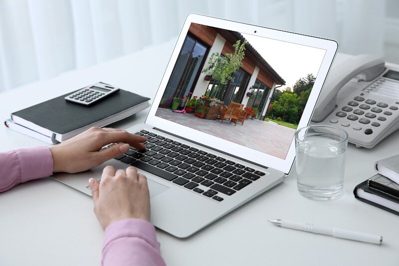 A woman uploads a lot of pictures of her home when listing it online.