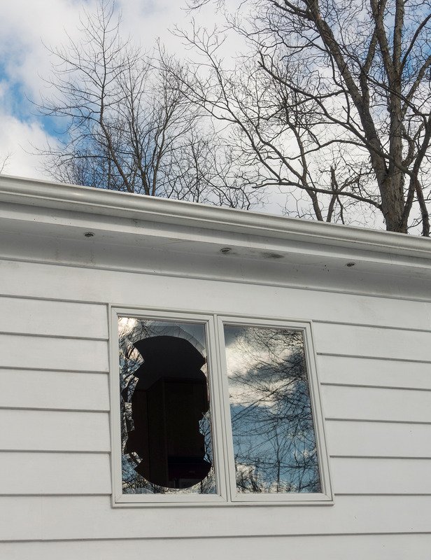 Vacant Houston house that has a broken window due to vandalism