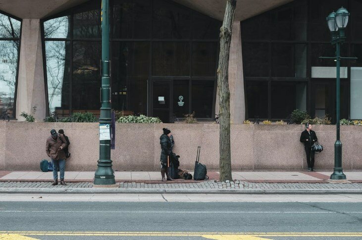 Three millennials waiting for a bus in Philadelphia
