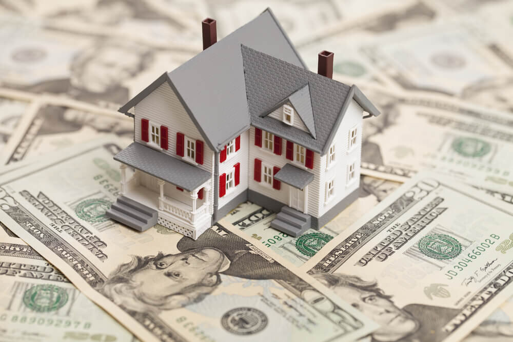 House over pile of money