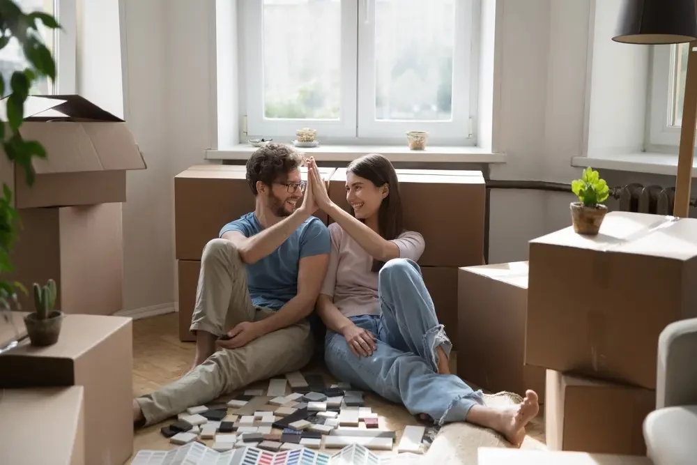 Happy couple moving after they sold their house with relief in their faces