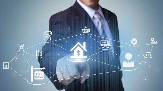 Real estate agent pressing a house button when hiring an agent in greenville nc