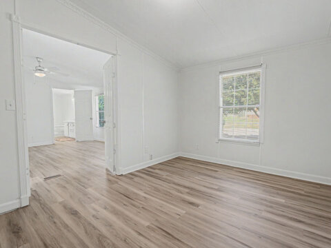 Bright secondary room with modern laminate flooring in the Greenville rent to own home.