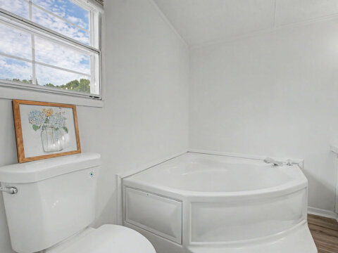 Full secondary bathroom with updated vanity in the rent to own property in Greenville 29607.
