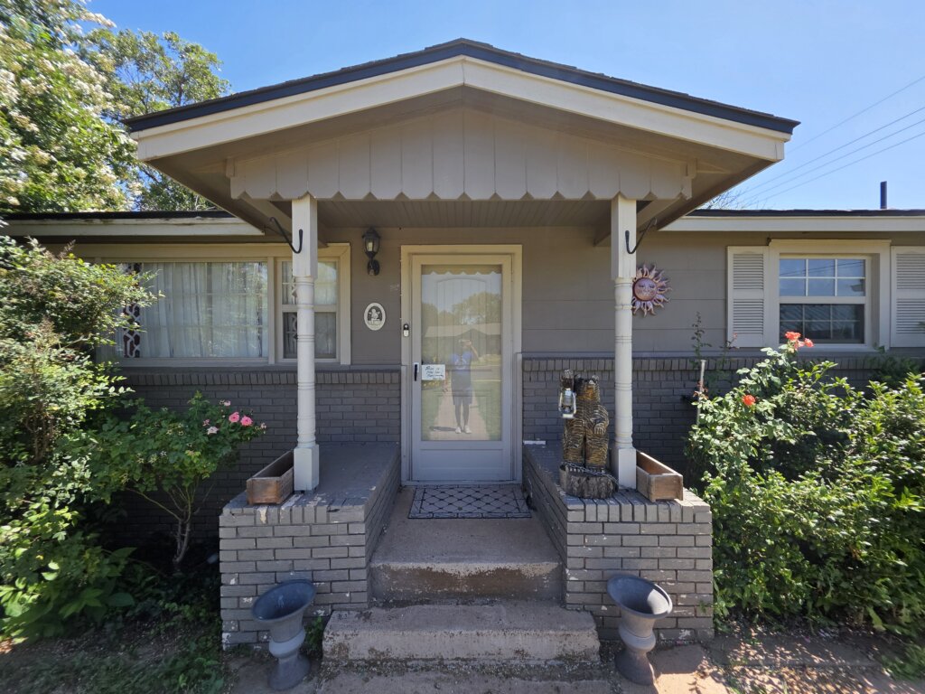 Exterior Of A Lubbock Texas Home With Porch And Flowers, Showing That Cash Home Buyers Make It Simple To Sell Your House Fast