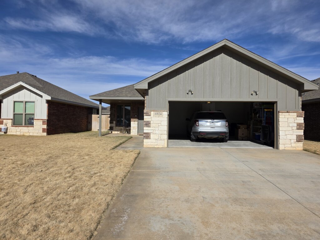 Single-story brick home with attached garage in Lubbock, Texas purchased by Electrum Properties.