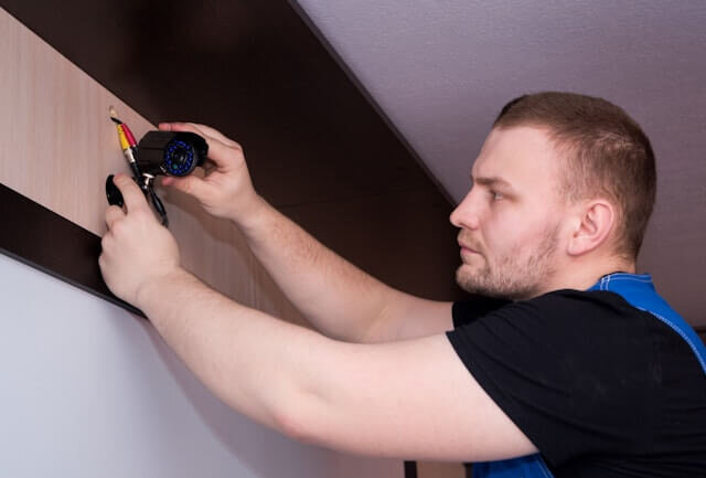 A man working on a wall with some tools