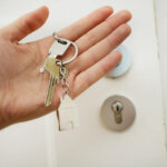 A person holding house keys