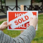 Person putting up a sign