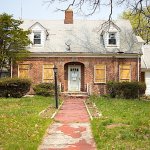 Vacant brick house with boarded-up windows: selling a hoarder house as-is in the Richmond, VA area