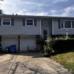 Outdated inherited home exterior in Rolling Meadows with peeling paint and overgrown landscaping