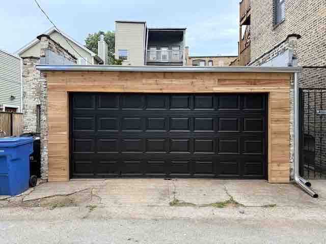 New modern garage door on a suburban home in Mount Prospect after exterior repairs.